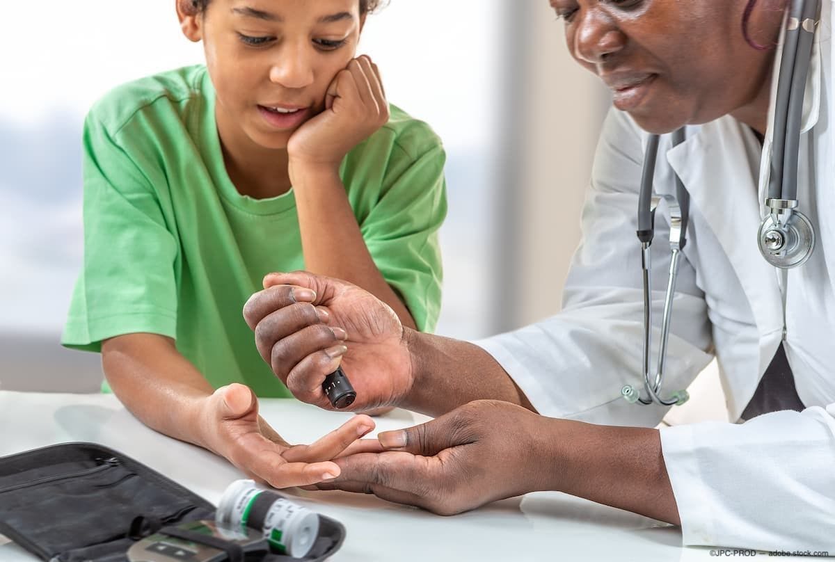 Physician checking child's glucose levels with glucometer Image Credit: AdobeStock/JPC-PROD