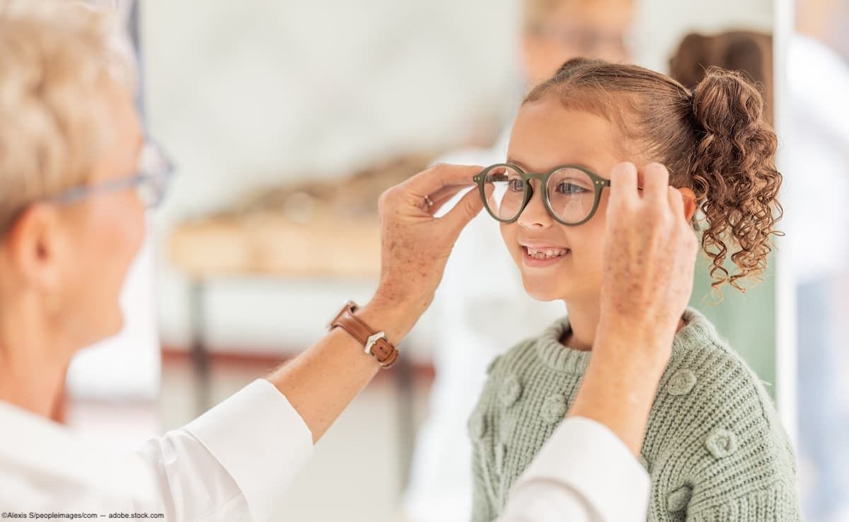 Adult helping child try on glasses Image Credit: AdobeStock/AlexisS/peopleimages.com
