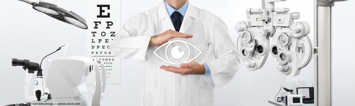 Physician with hands around eye graphic in eye doctor's office Image Credit: AdobeStock/amedeoemaja