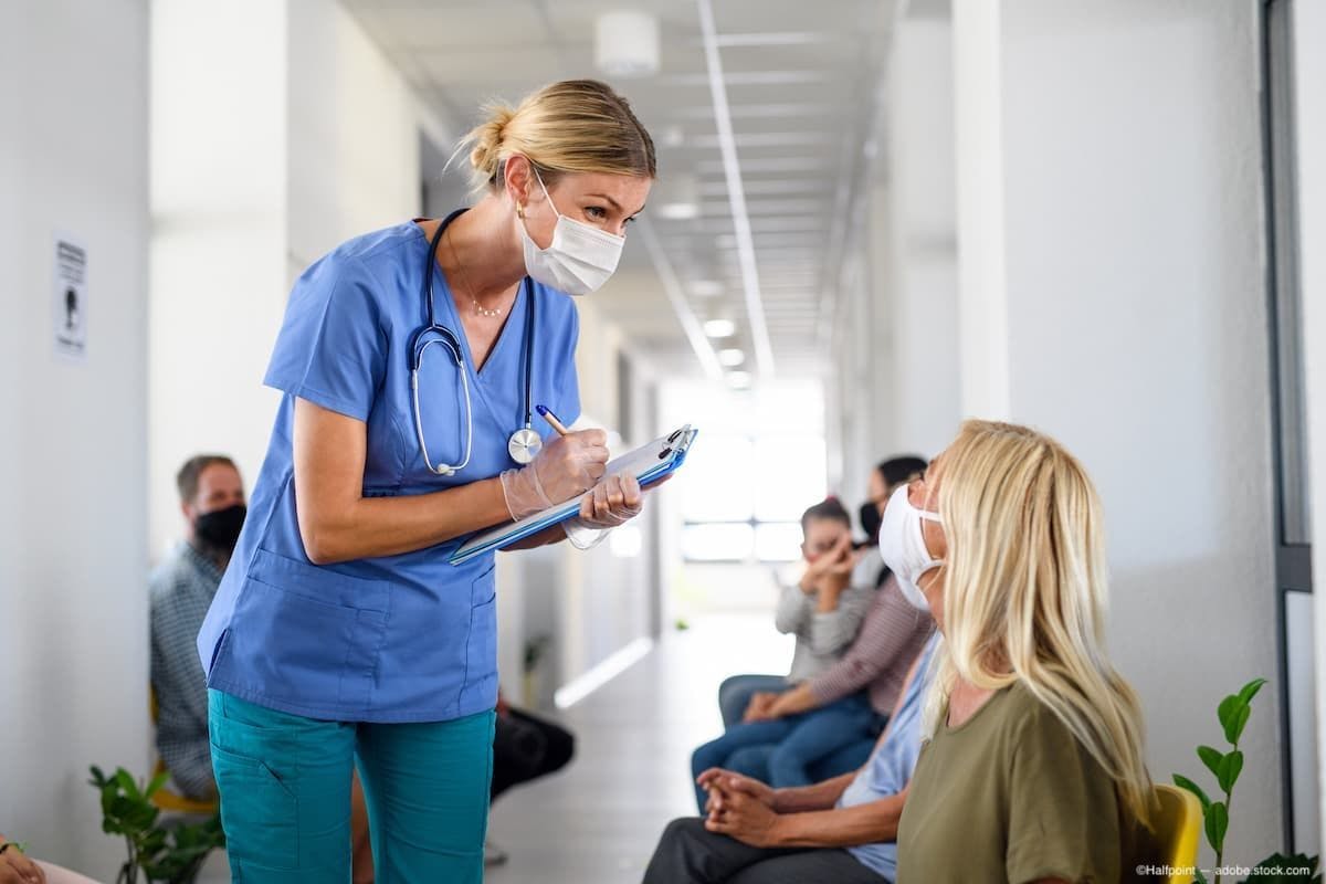 Physician speaking with patient in waiting room Image Credit: AdobeStock/Halfpoint