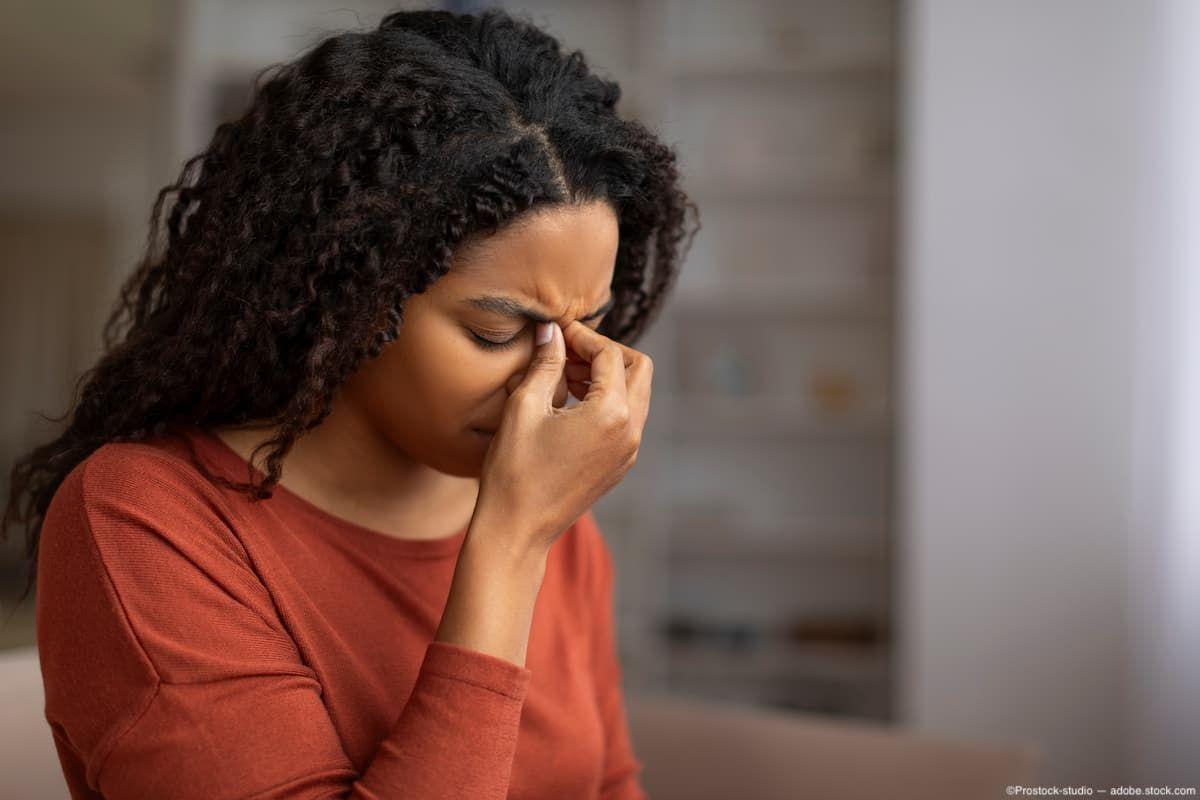 Woman with sinus pressure holding bridge of nose Image credit: AdobeStock/Prostock-studio