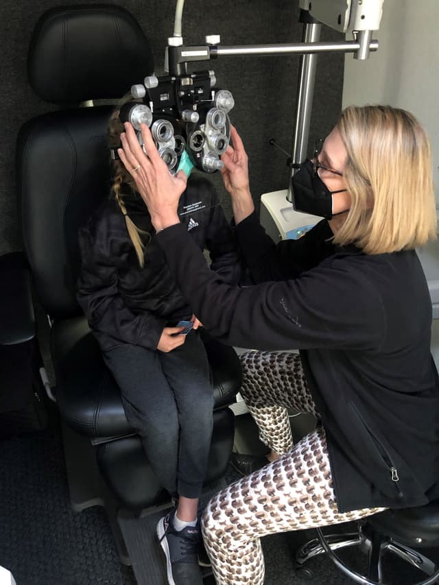 Susan Quinn, OD, examines a pediatric patient on the Vision to Learn van. Image credit: Vision to Learn