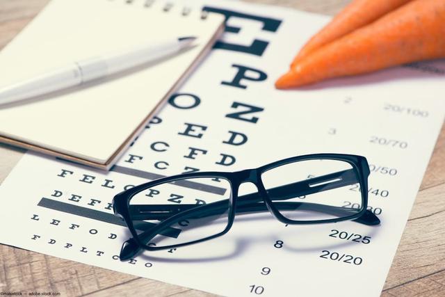 Glasses and carrots laying on visual acuity card Image credit: ©makistock - adobe.stock.com