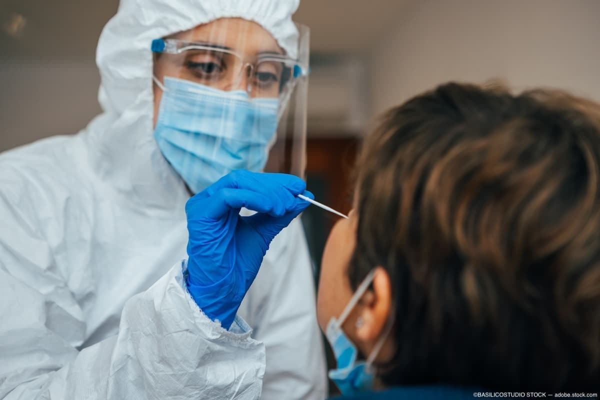 Patient getting tested for COVID-19 by physician in PPE Image credit: AdobeStock/BASILICOSTUDIOSTOCK