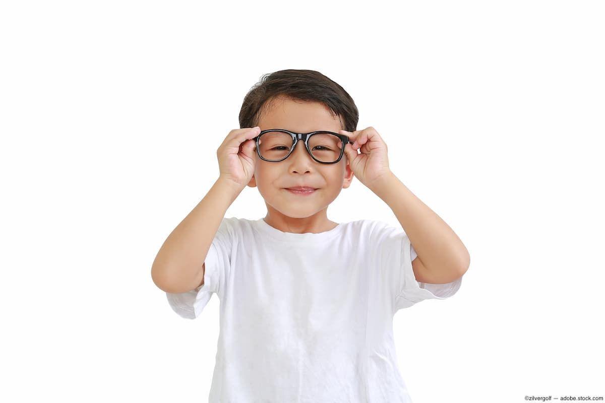 Child putting on glasses Image credit: AdobeStock/zilvergolf