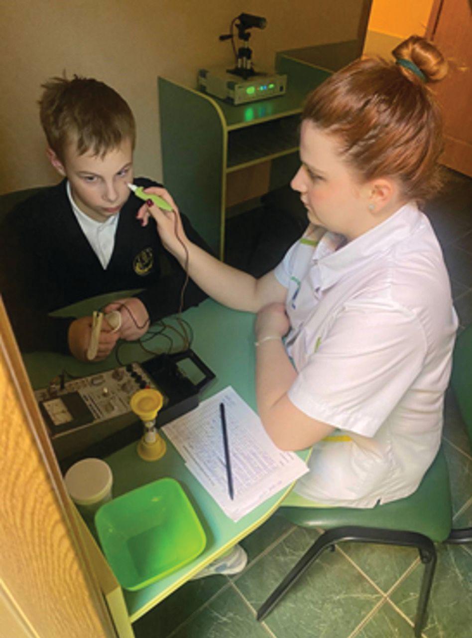 A pediatric patient undergoes electropuncture therapy to stimulate the ciliary muscle. (Image courtesy of Rodica Bilba, MD, PhD.)