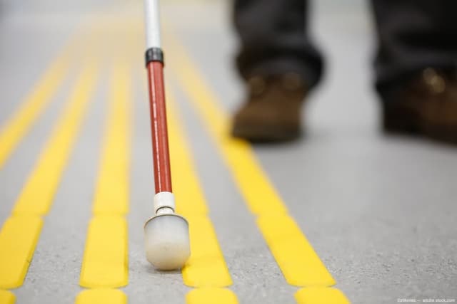 White cane on pavement Image credit: AdobeStock/zlikovec