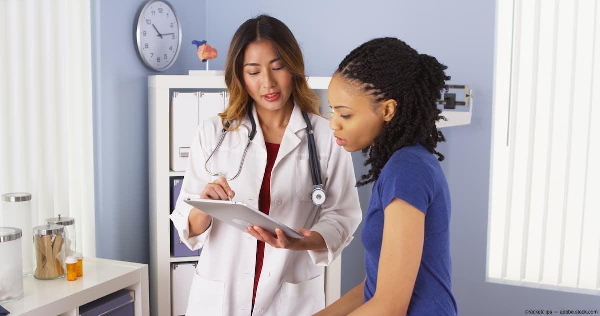 Physician going over chart with patient in office Image Credit: AdobeStock/rocketclips