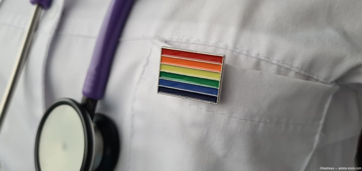 LGBT rainbow pin on clinician's white coat Image credit: ©Nadzeya - adobe.stock.com