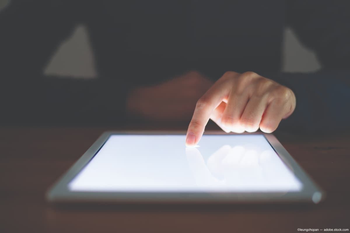 Finger on tablet screen Image credit: AdobeStock/leungchopan