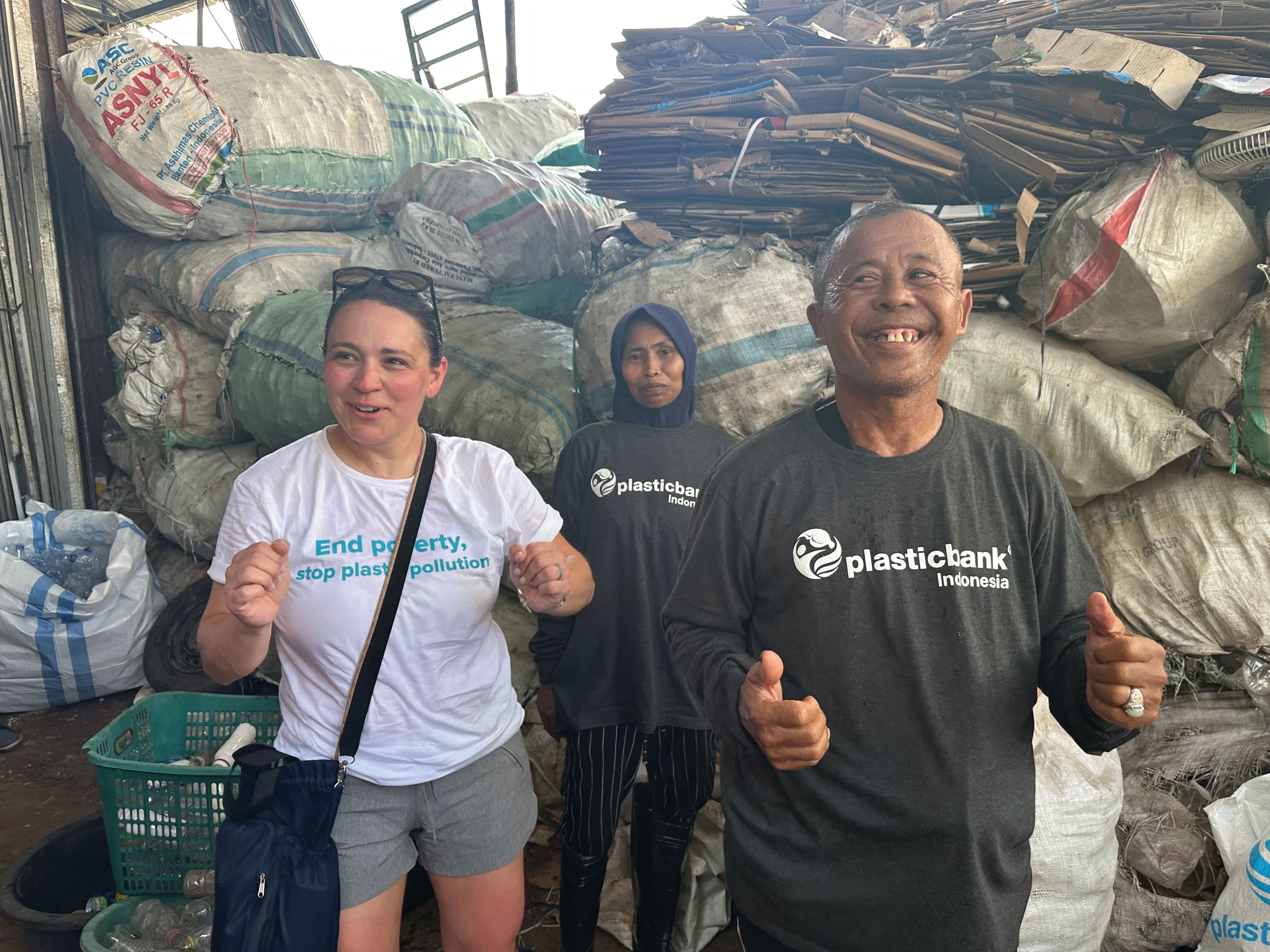 Victory dance after plastic collection in the community with local Plastic Bank collector. Image courtesy of CooperVision.