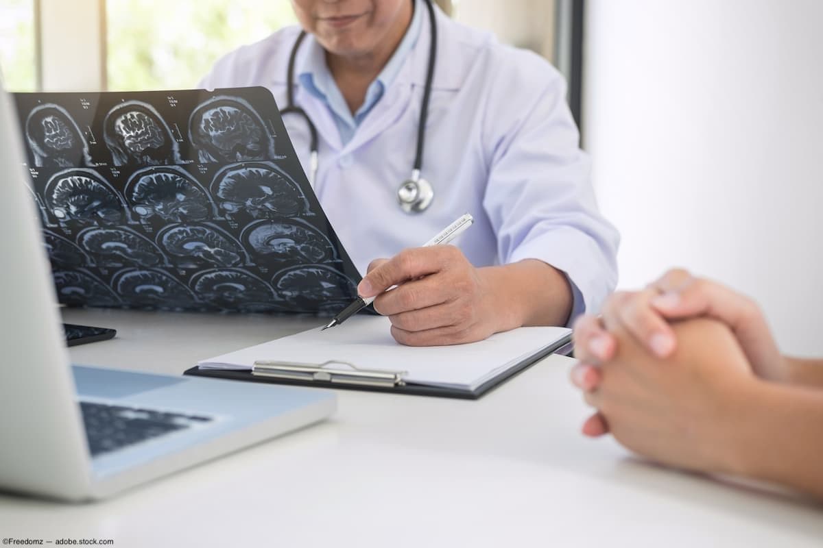 Doctor discussing MRI results with patients at desk Image credit: ©Freedomz - adobe.stock.com