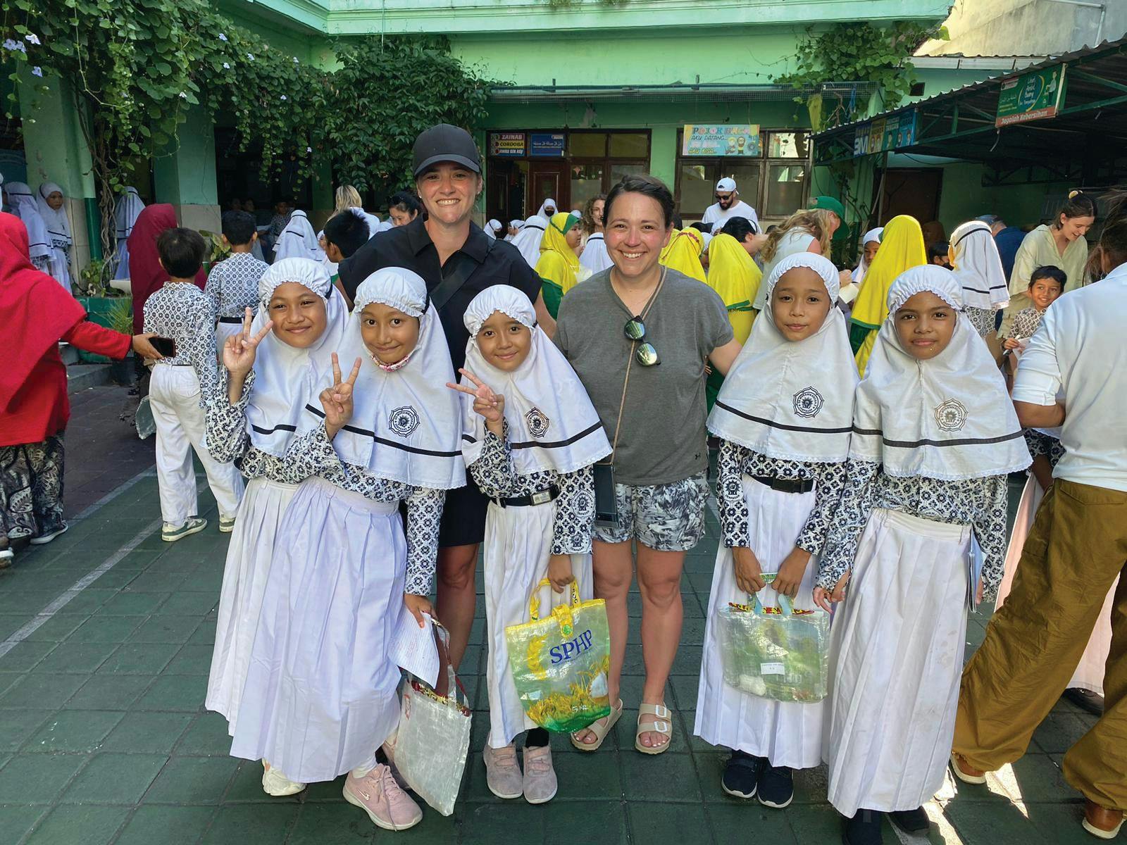 Visiting one of the local schools that partners with Plastic Bank to educate younger generations about the importance of recycling. (Jenna Van Thof from CooperVision joins the author in this photo.)