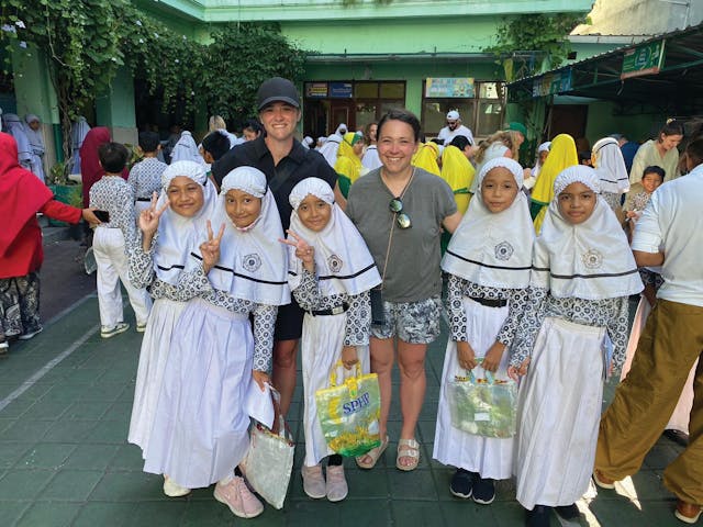 Visiting one of the local schools that partners with Plastic Bank to educate younger generations about the importance of recycling. (Jenna Van Thof from CooperVision joins the author in this photo.)